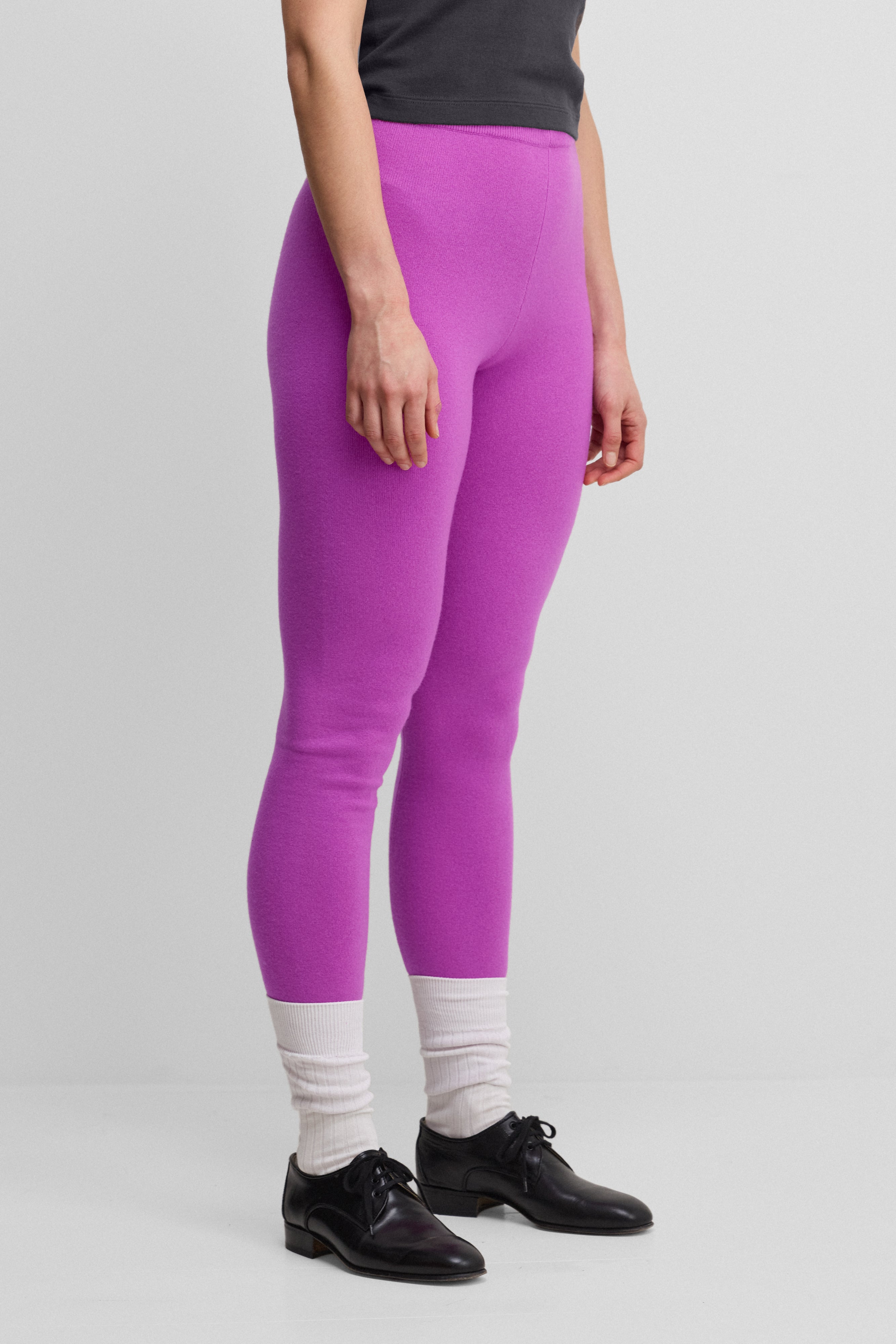 woman wearing bright pink cashmere leggings.