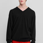 man wearing a black cashmere v-neck sweater with ribbed trims.