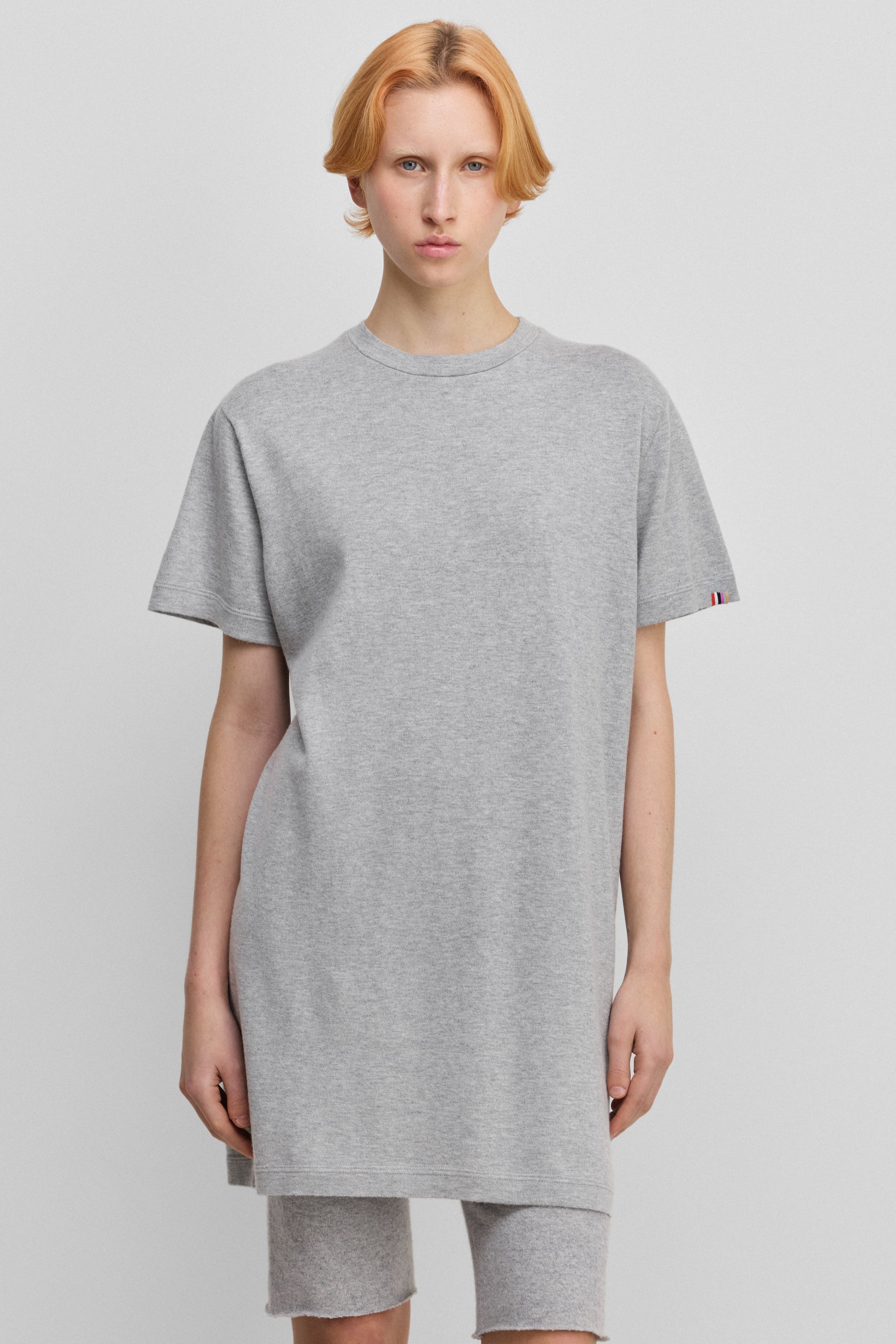 woman wearing a light grey cotton-cashmere mini t-shirt dress.