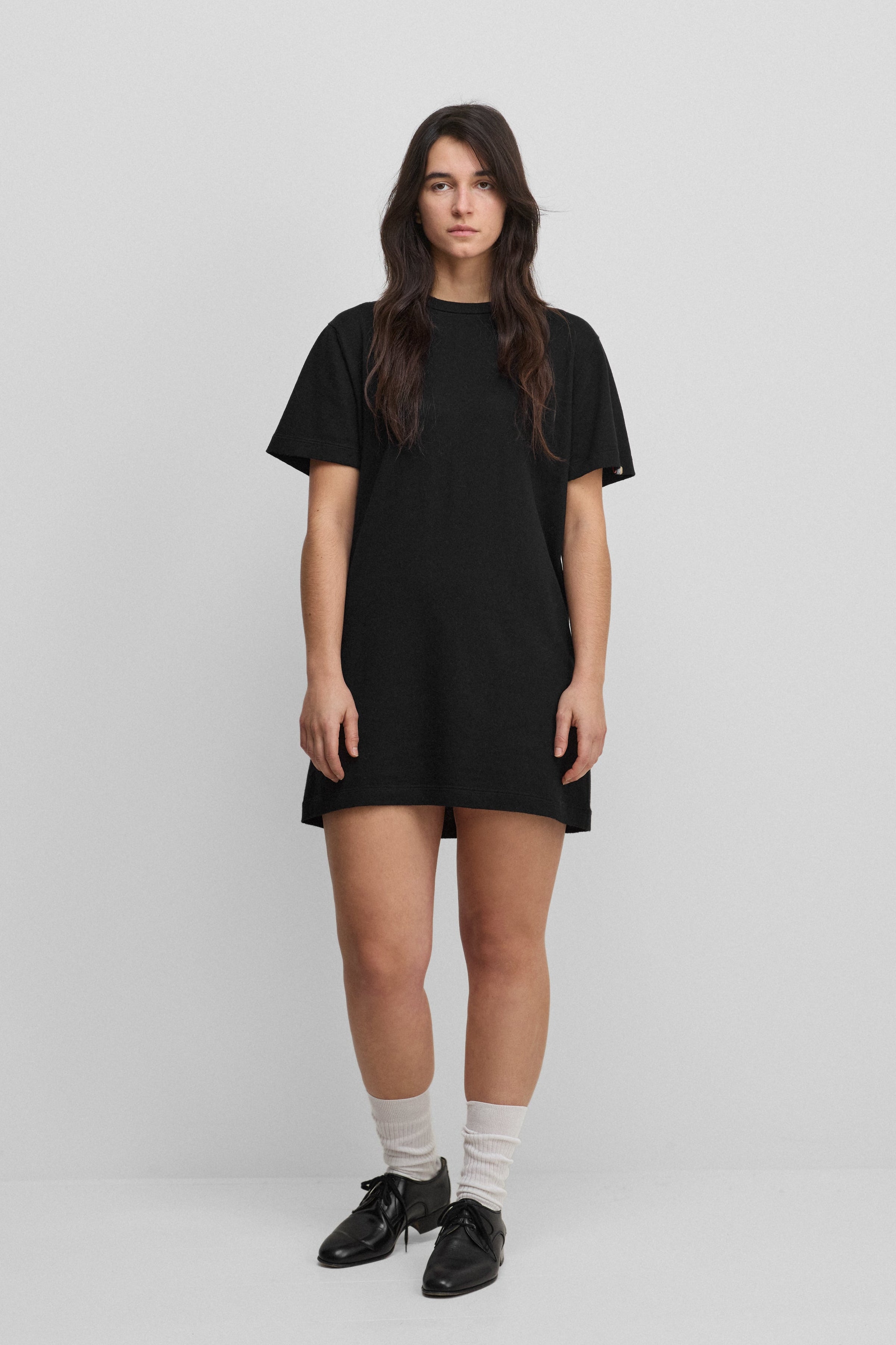 woman wearing a black cotton-cashmere mini t-shirt dress.