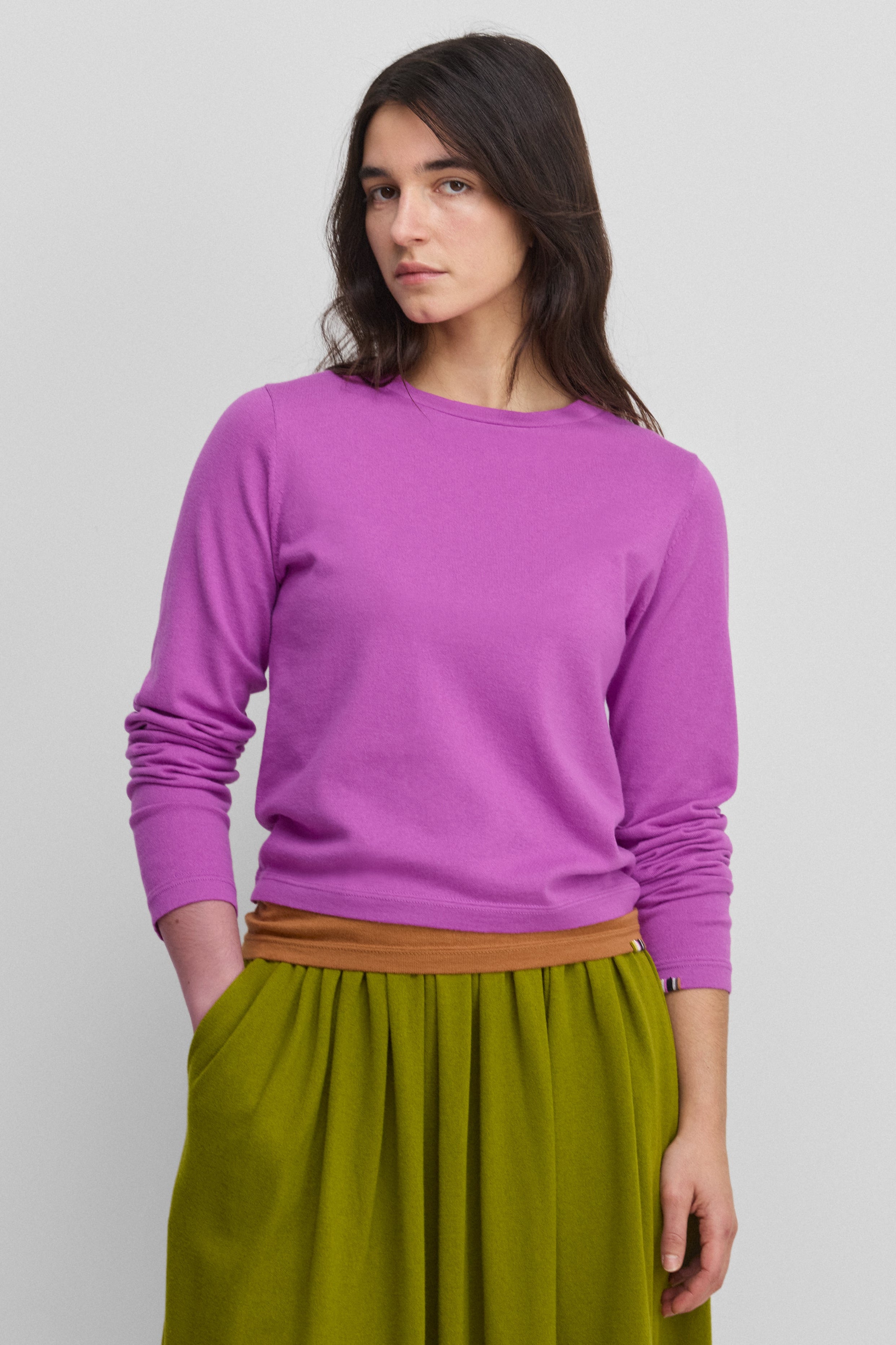 woman wearing a bright pink long-sleeved cotton cashmere crewneck t-shirt.