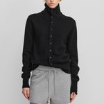 woman wearing a black cashmere button-up cardigan with a rib-knitted collar.