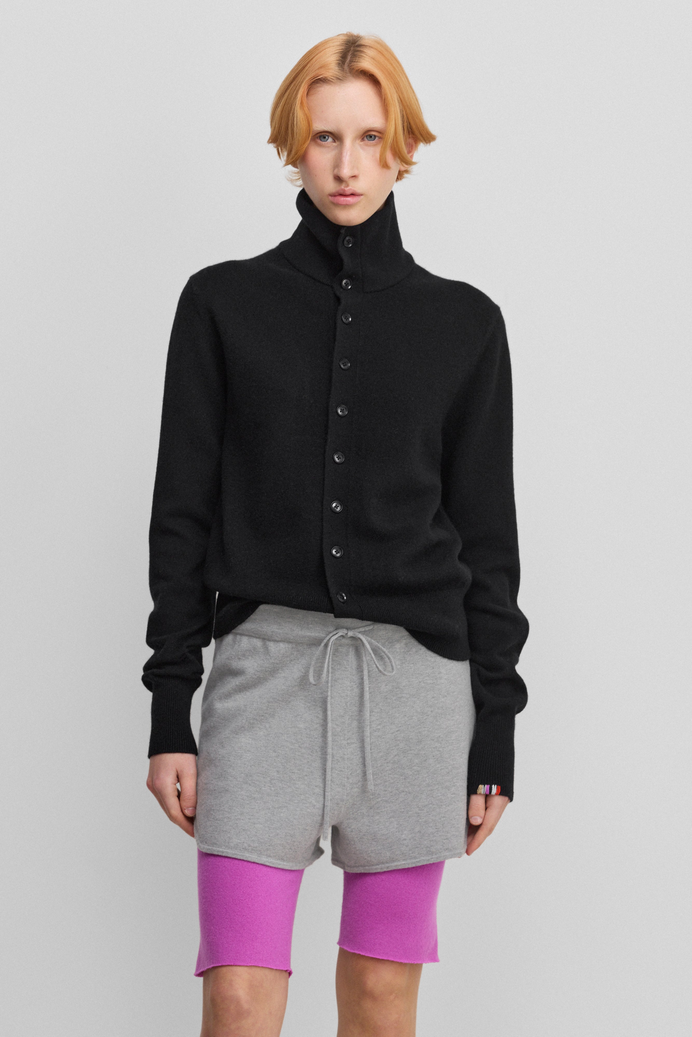 woman wearing a black cashmere button-up cardigan with a rib-knitted collar.