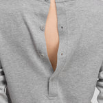 detail of the four corozo buttons on the back of a grey long-sleeved cotton cashmere top.