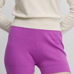 woman wearing fitted bright pink cotton cashmere rib-knit shorts.