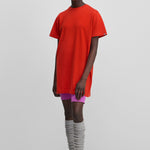 woman wearing a bright red cotton-cashmere mini t-shirt dress.