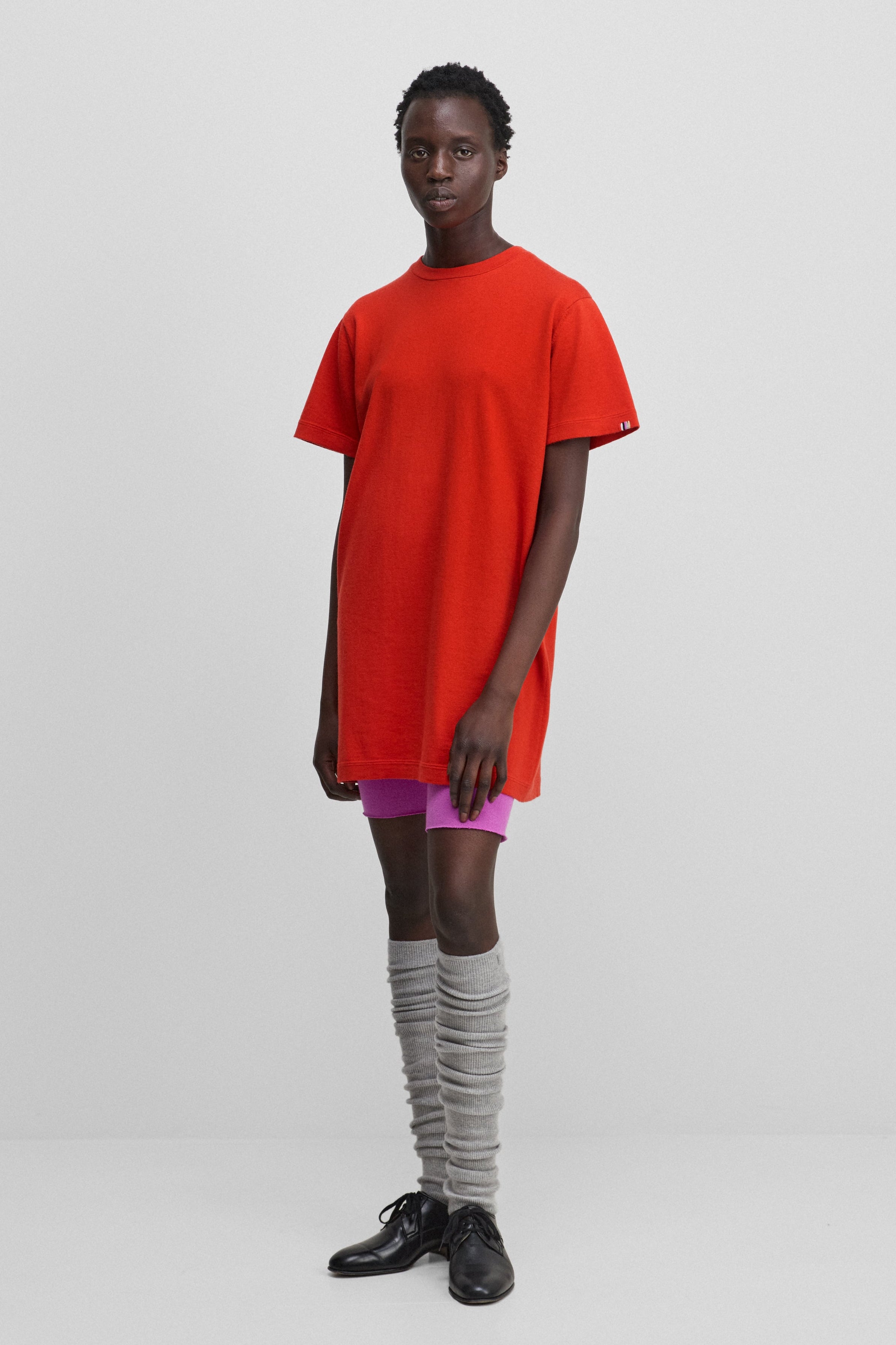 woman wearing a bright red cotton-cashmere mini t-shirt dress.