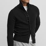 man wearing a slim-fit black cashmere button-up cardigan with a rib-knitted collar.
