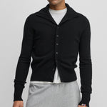 man wearing a black cashmere button-up cardigan with a rib-knitted collar.