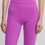 woman wearing bright pink cashmere biker shorts with ribbed elasticated waistband.