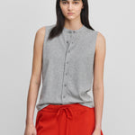 woman wearing a grey sleeveless cotton-cashmere vest with corozo buttons and a crewneck.
