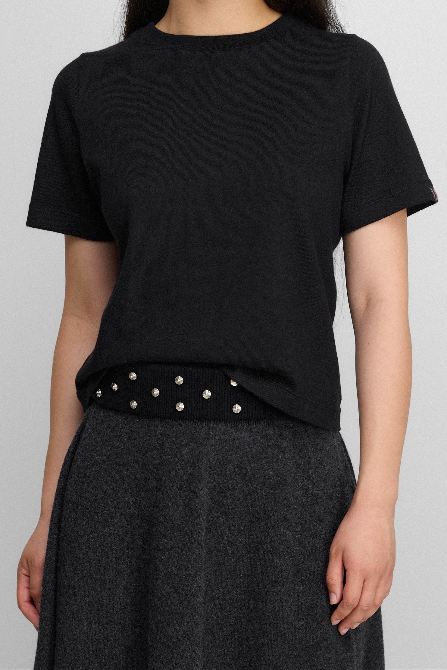 woman wearing a black cropped short-sleeved cotton cashmere crewneck t-shirt.