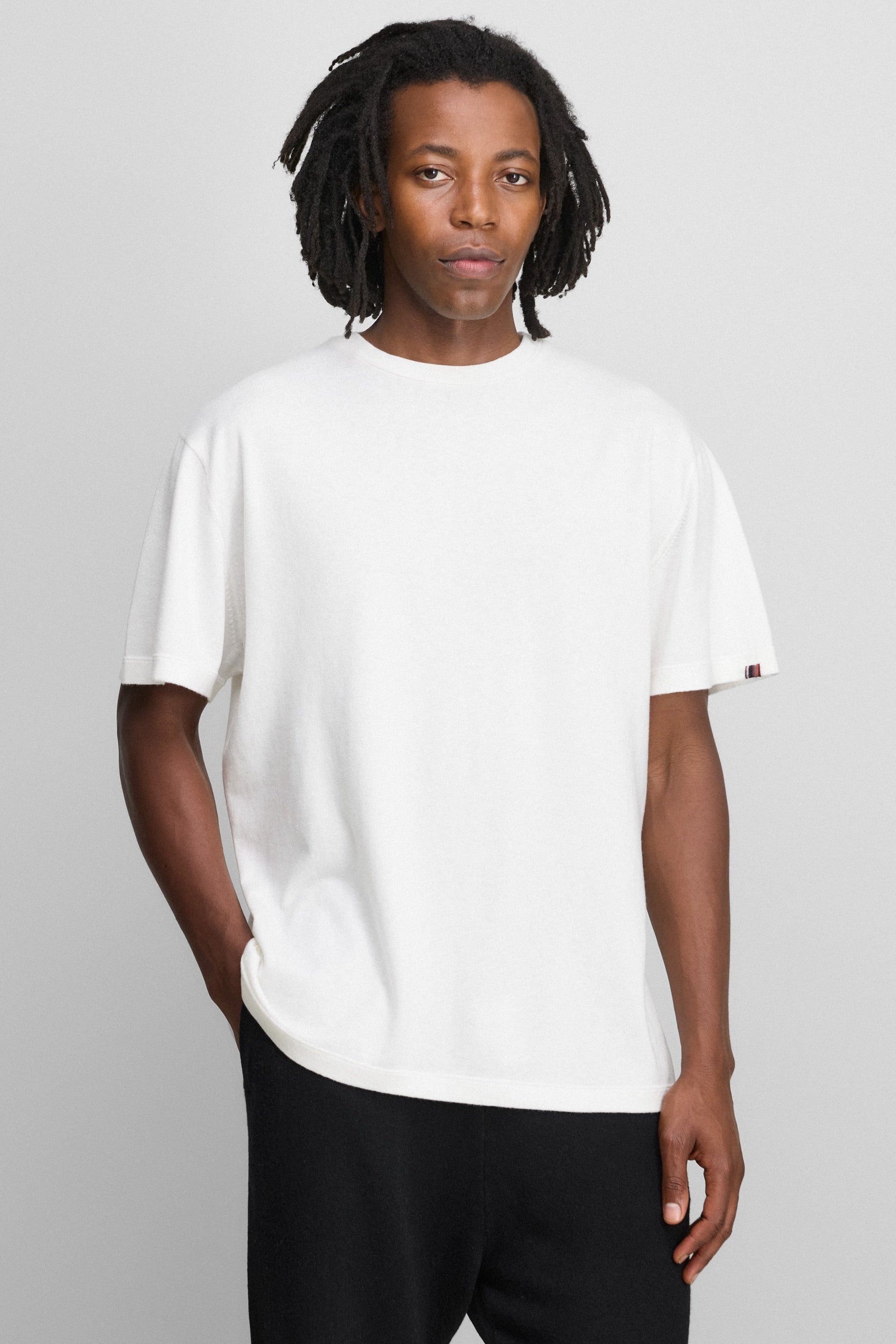 man wearing a white relaxed-fit short-sleeved cotton-cashmere crewneck t-shirt.
