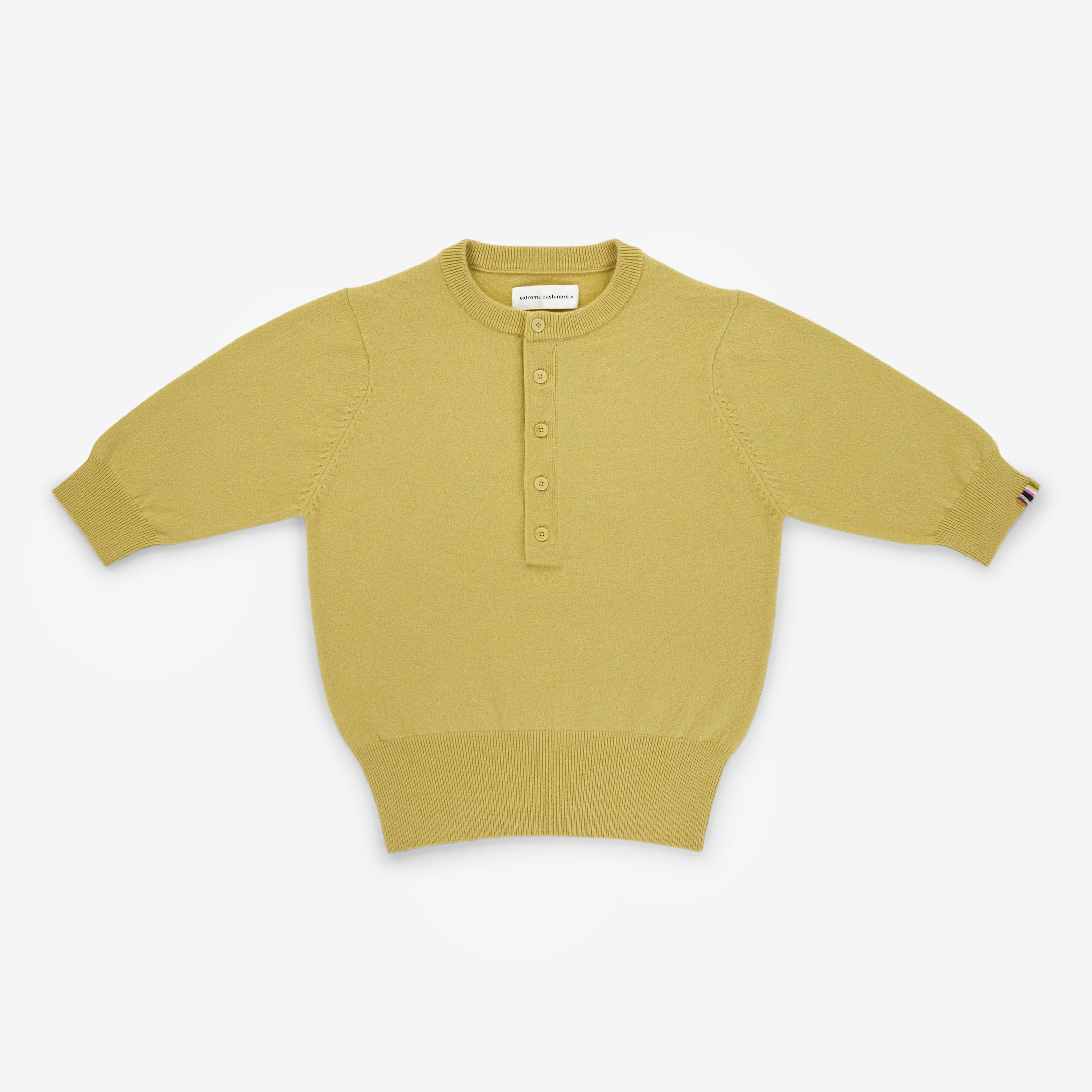 yellow short-sleeved half-button cashmere sweater, laid flat.